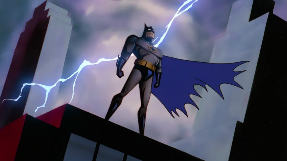 Batman stands on a building as lightning strikes behind him in 'Batman: The Animated Series'