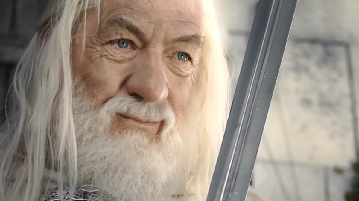 Gandalf is looking at a sword in Lord of the Rings.