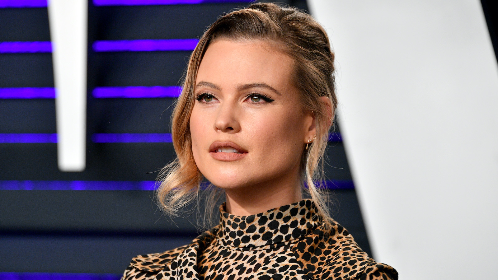 Close up of Behati Prinsloo in a cheetah print dress on the red carpet