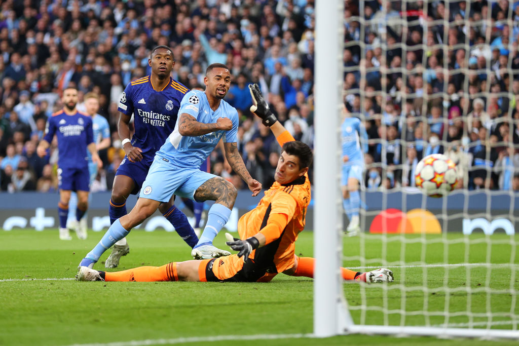 Gabriel Jesus of Manchester City scores past Real Madrid goalie Thibaut Courtois.