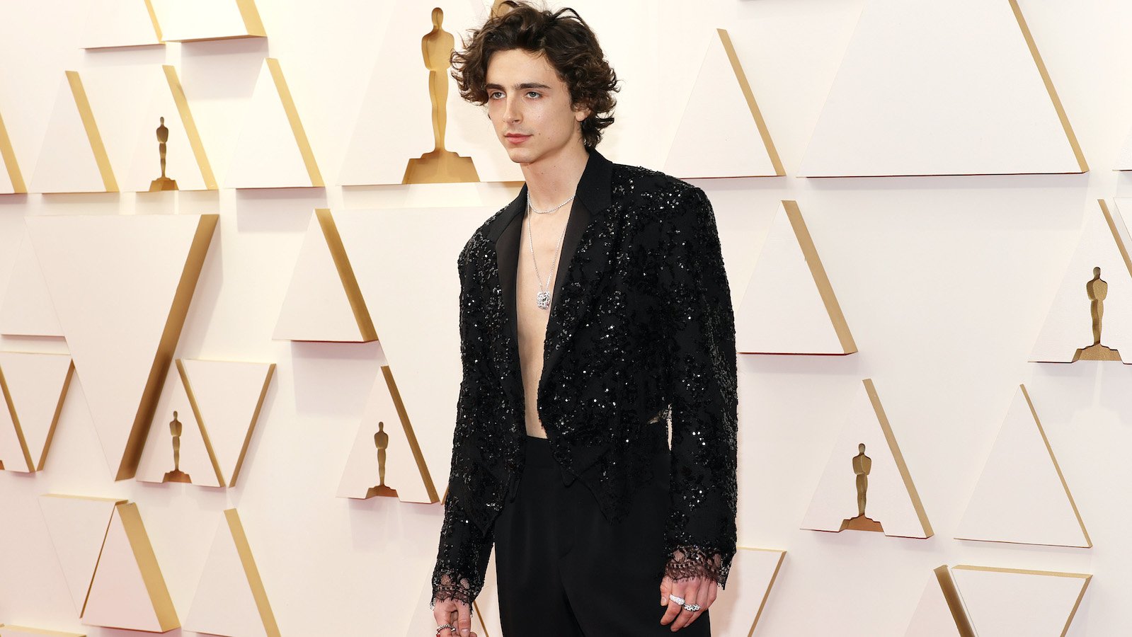 Timothée Chalamet posing at the 2022 Academy Awards ceremony held at the Dolby Theatre in Hollywood, Los Angeles.