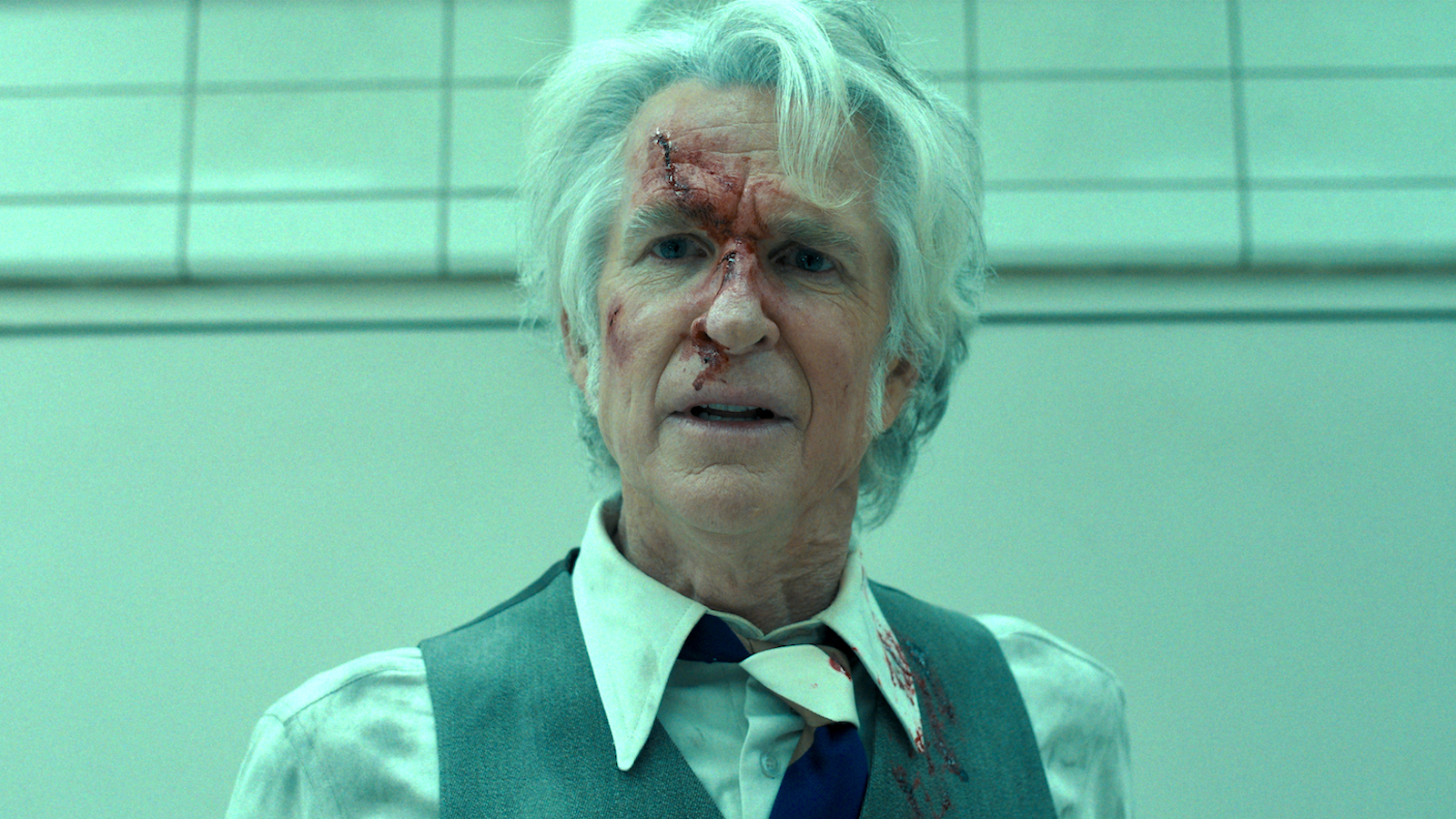 Matthew Modine as Dr. Brenner/Papa has messy hair and a bloody face in Stranger Things