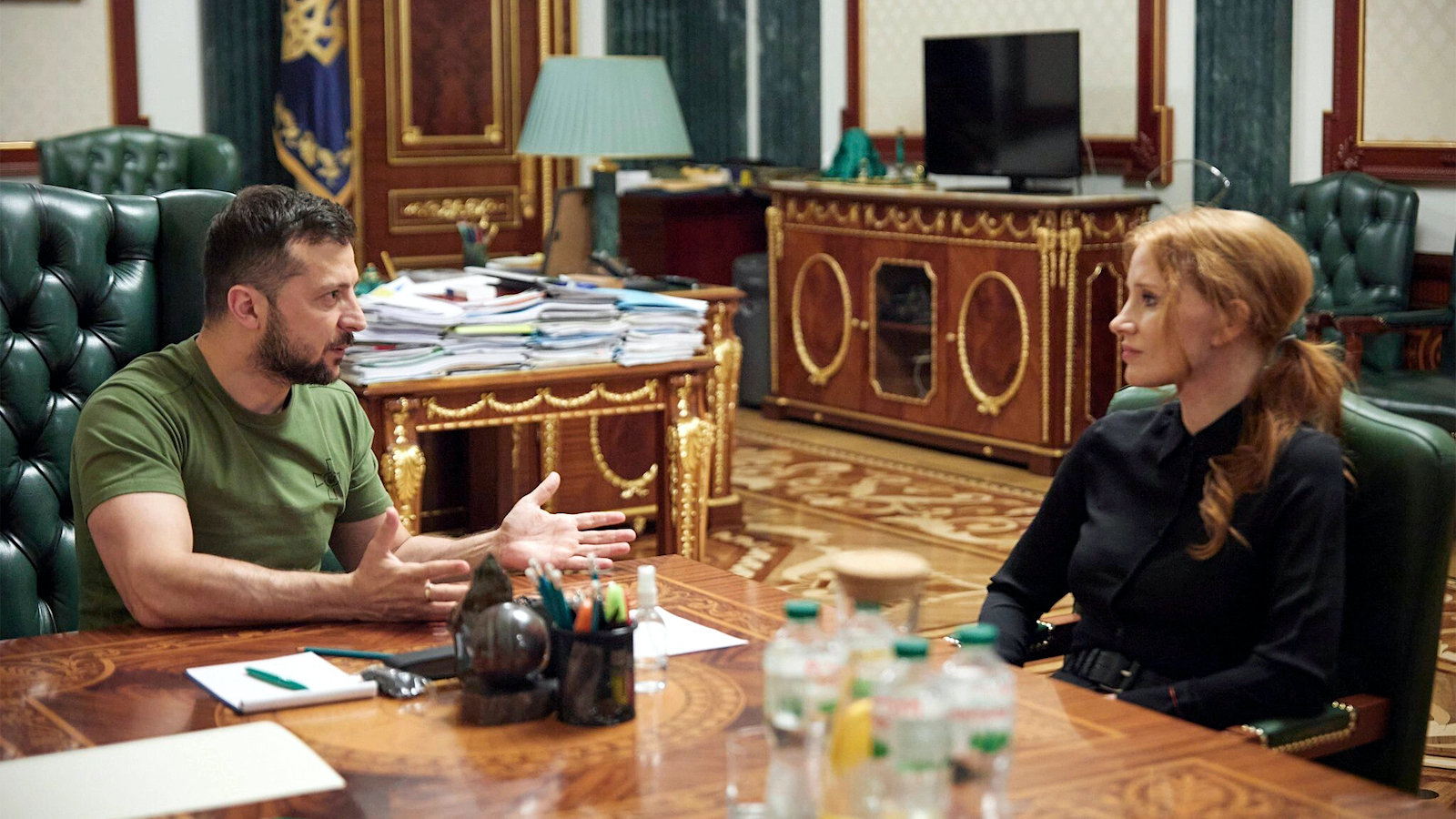 Jessica Chastain sitting across from with Ukrainian President Volodymyr Zelensky in presidential office