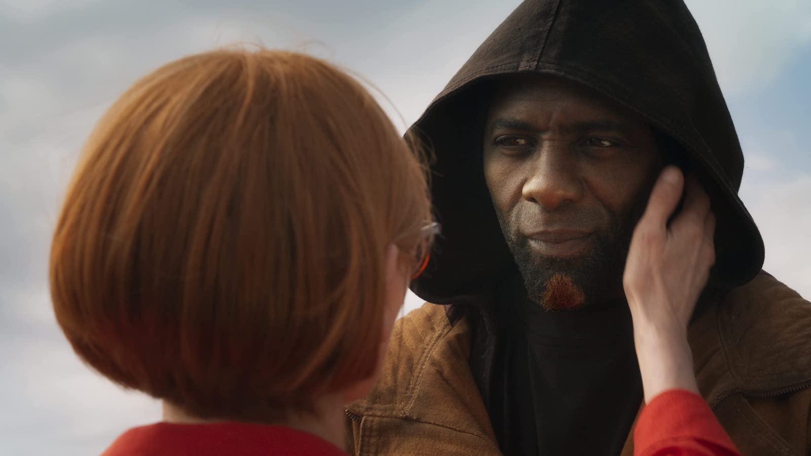 Tilda Swinton embraces Idris Elba's cheek in Three Thousand Years of Longing