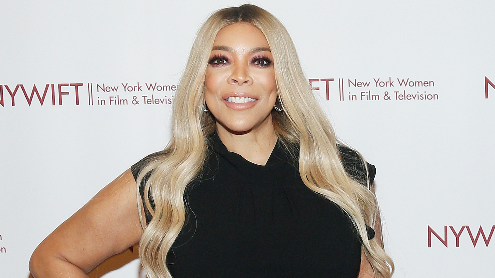 Wendy Williams sports long blonde hair and a black dress on the red carpet