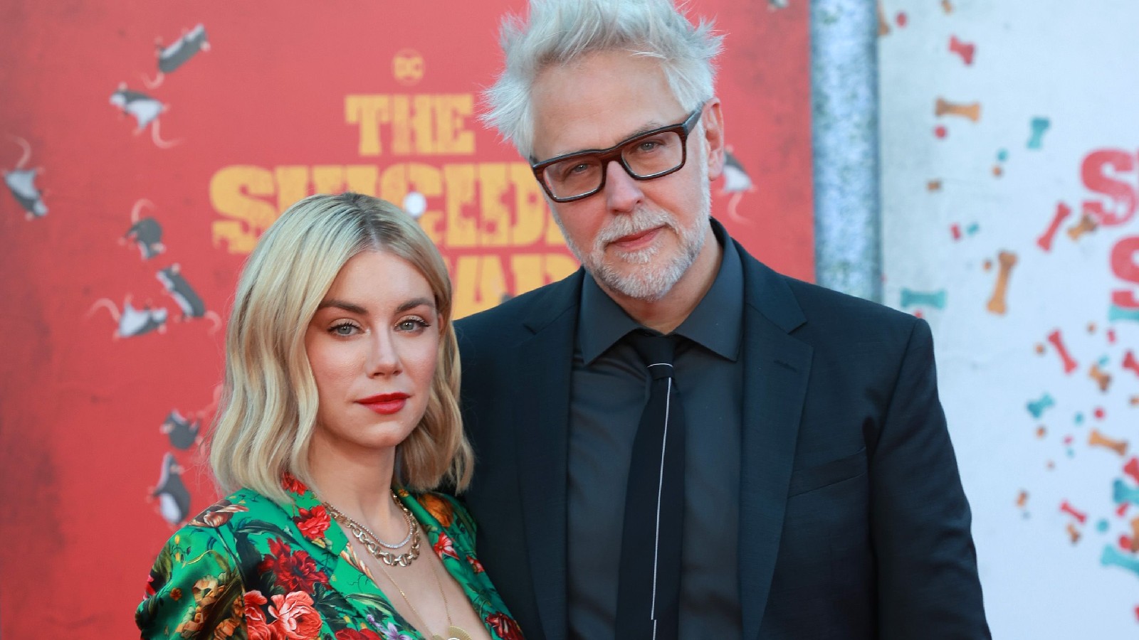 James Gunn and Jennifer Holland pose at a red carpet event.