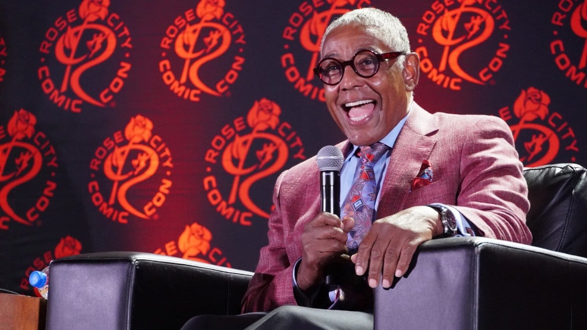 Giancarlo Esposito sports a dapper purpler blazer during a Q&A panel.