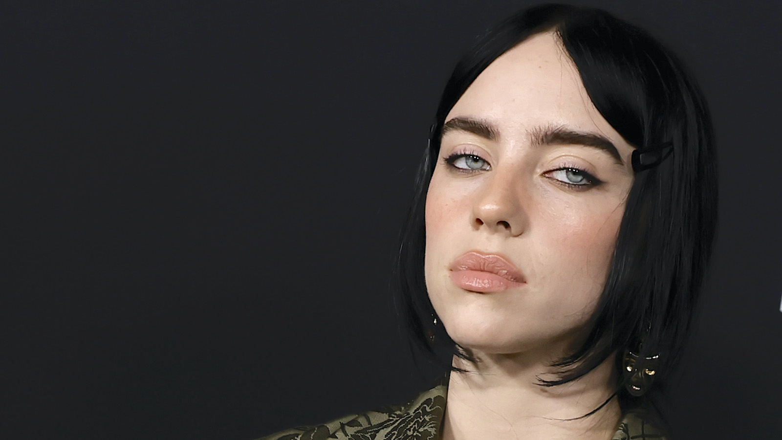 Close up shot Billie Eilish sporting black hair and signature piercing blue eyes