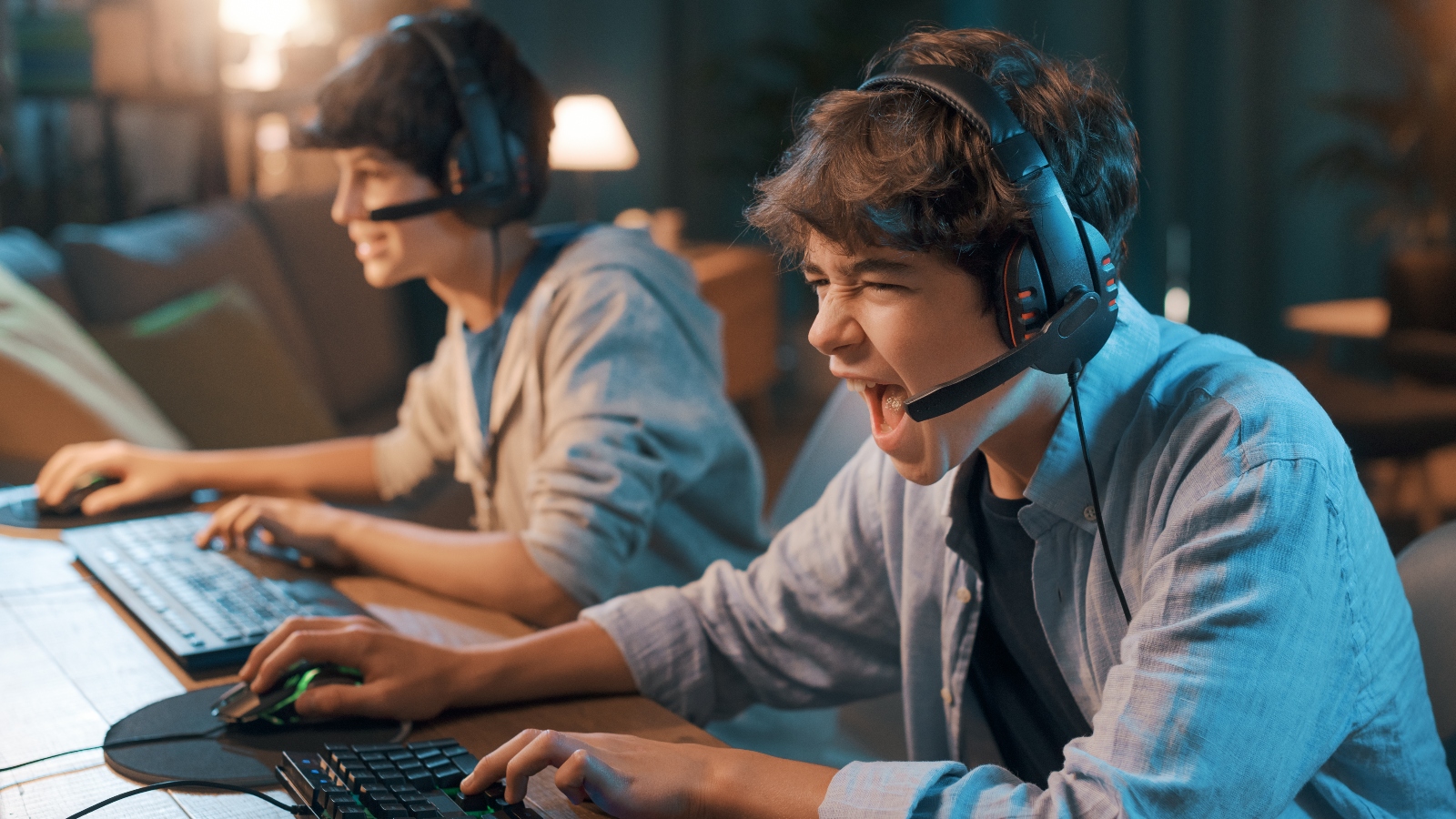 Gamers playing online video games together - stock photo