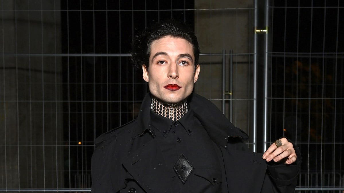 Ezra Miller attends Burberry closing party for Anne Imhof's Exhibition 'Natures Mortes'at Palais de Tokyo on October 18, 2021 in Paris, France wearing all black and red lipstick.