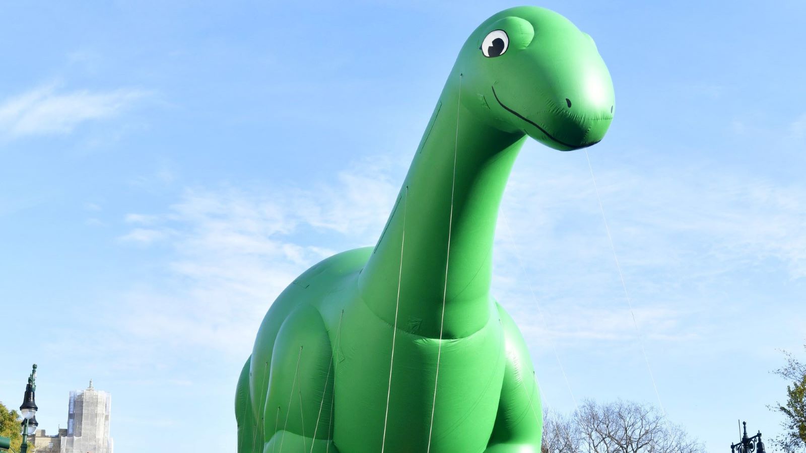 View of the Sinclair Dinosaur balloon is seen as 95 And Marching On! Macy's Parade® Thanksgiving Day ushers in the Holiday Season on November 25, 2021 in New York City. (Photo by Eugene Gologursky/Getty Images for Macy's Inc.)