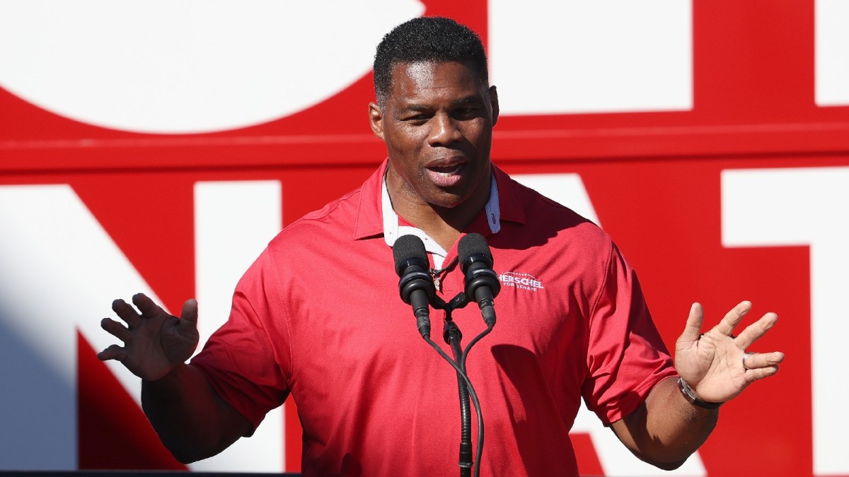 Herschel Walker gives a speech at a podium.