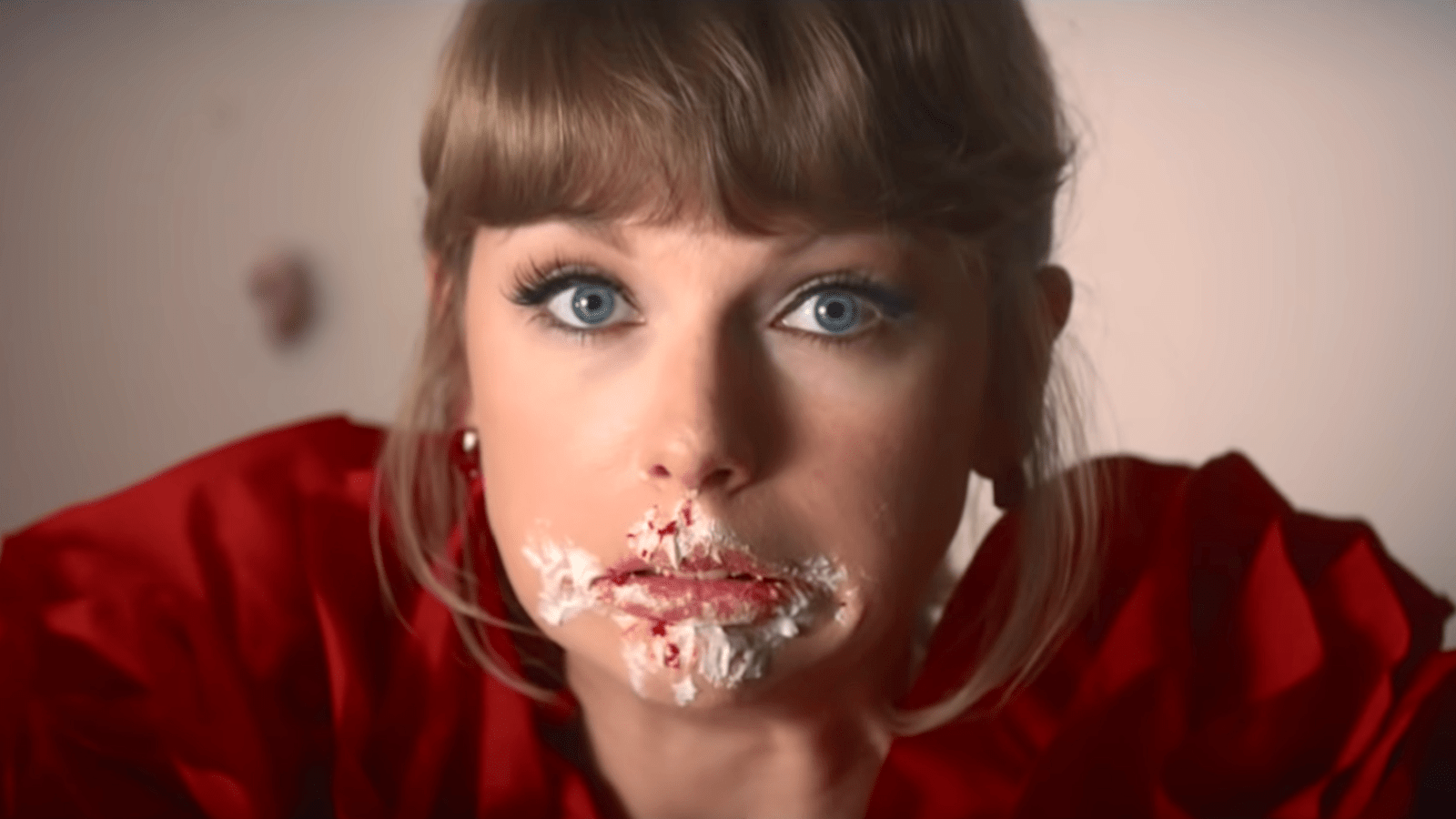 Taylor Swift with a face full of cake