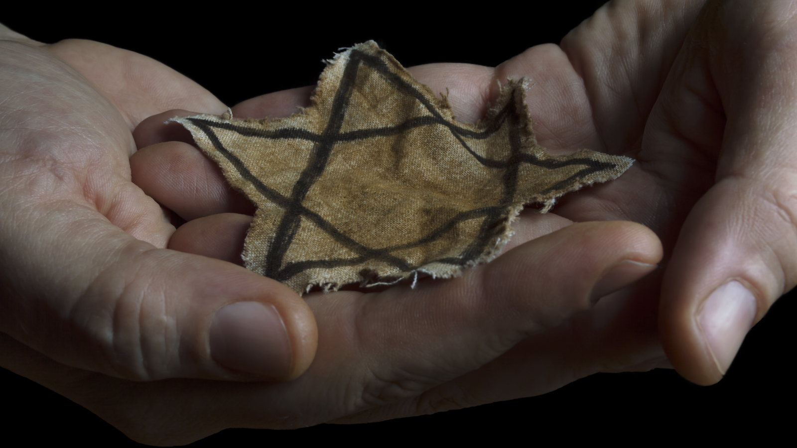 Jewish badge in the hands of a man