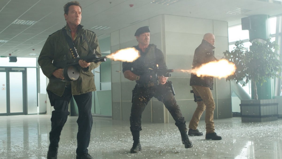 A gun-fighting scene from The Expendables 2 featuring Sylvester Stallone and Dolph Lundgren.