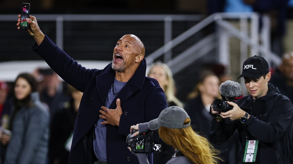 WASHINGTON, DC - FEBRUARY 19: (L-R) XFL owner Dwayne Johnson reacts during the first half of the XFL game between the DC Defenders and the Seattle Sea Dragons at Audi Field on February 19, 2023 in Washington, DC.