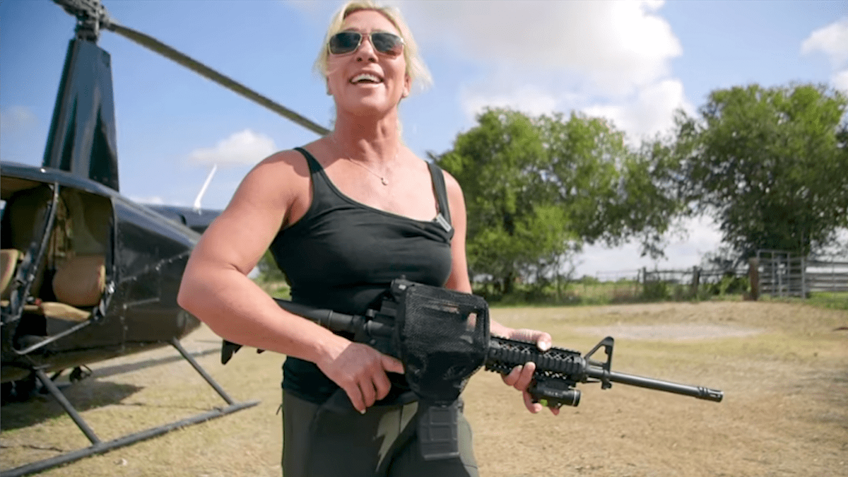 Marjorie Taylor Greene holding an AR-15 rifle