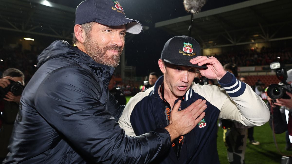 WREXHAM, WALES - APRIL 22: Wrexham owners Ryan Reynolds and Rob McElhenney as Wrexham celebrate promotion back to the English Football League during the Vanarama National League match between Wrexham and Boreham Wood at Racecourse Ground on April 22, 2023 in Wrexham, Wales.