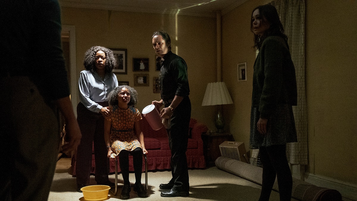 Archive 81. (L to R) Gameela Wright as Erica Lewis, Ariana Neal as Jess, Martin Sola as Father Russo, Dina Shihabi as Melody Pendras in episode 103 of Archive 81.