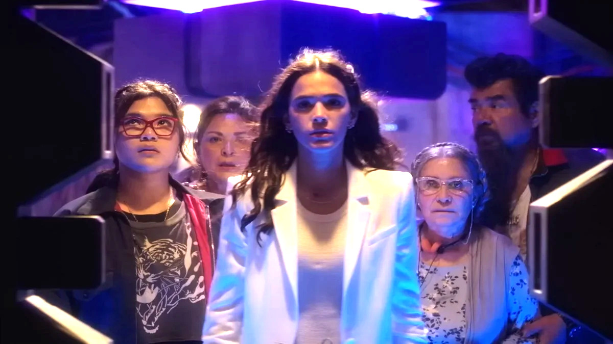 Belissa Escobedo as Milagro Reyes, Bruna Marquezine as Jenny Kord, Adriana Barraza as Nana Reyes, and George Lopez as Rudy Reyes in "Blue Beetle"