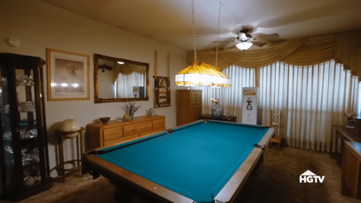 A pool table in an ornate and formal '70s dining room. 