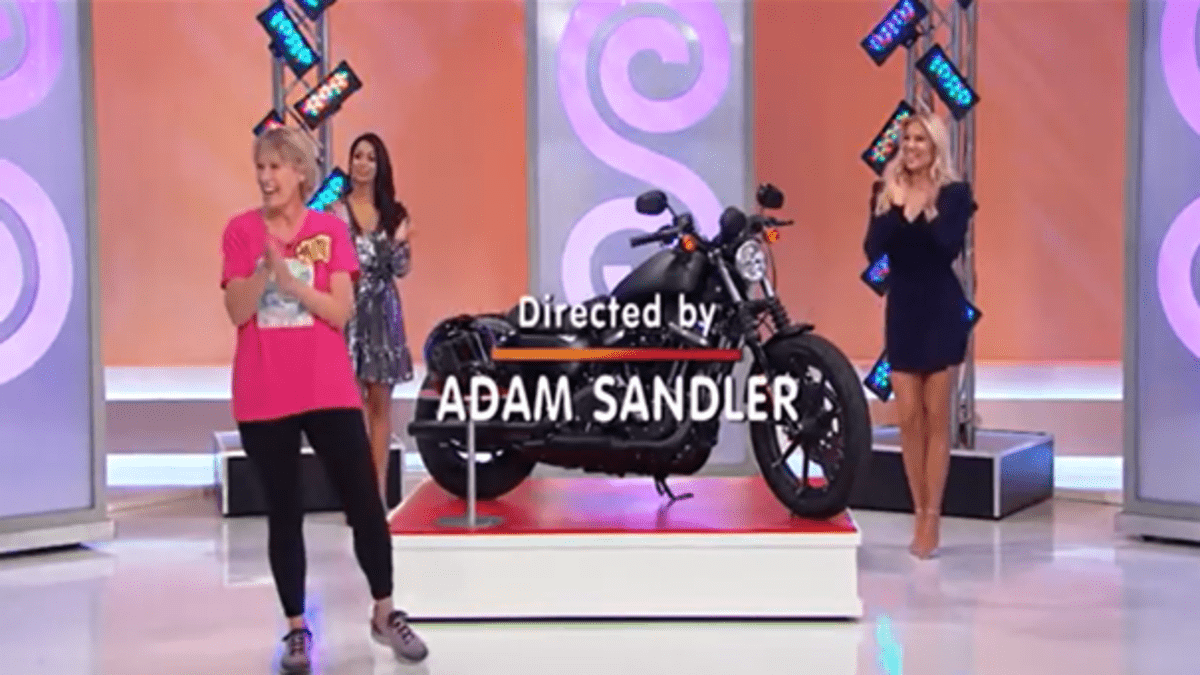 A contestant and two models beside a motorcycle on "The Price Is Right" as the credits roll. 