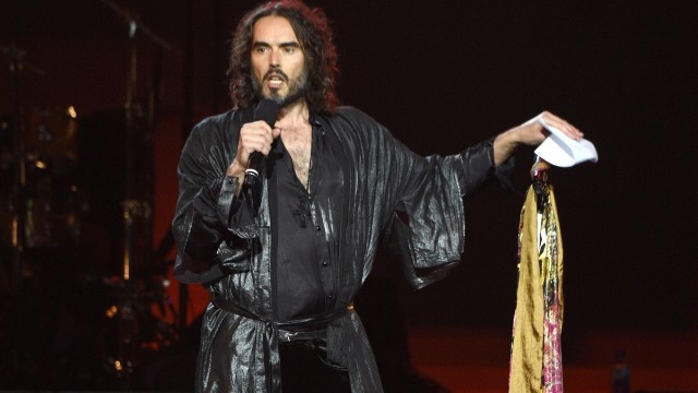 LOS ANGELES, CALIFORNIA - JANUARY 24: Russell Brand speaks onstage during MusiCares Person of the Year honoring Aerosmith at West Hall at Los Angeles Convention Center on January 24, 2020 in Los Angeles, California.