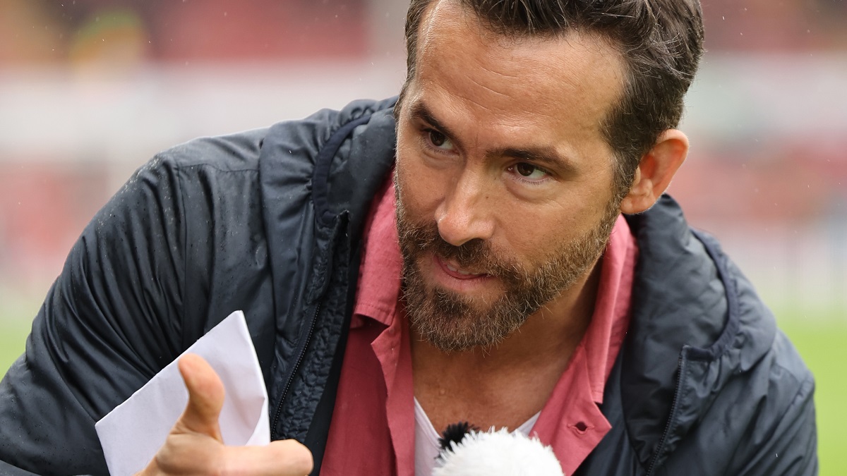 WREXHAM, WALES - AUGUST 5: Ryan Reynolds the co-owner of Wrexham receives a toy panda wearing a Wrexham shirt from a fan prior to Wrexham's first game back in the football league prior to the Sky Bet League Two match between Wrexham and Milton Keynes Dons at Racecourse Ground on August 5, 2023 in Wrexham, Wales.