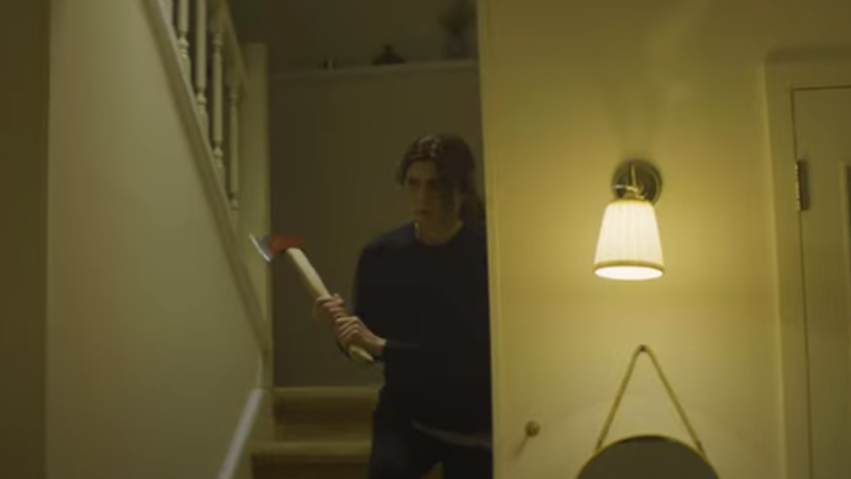 A woman with an axe in 'John Carpenter's Suburban Screams'