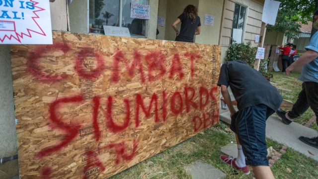 Activists break into the house of Kaotar Dee, to get her and her possessions back into her home of 21 years and for her to make a barricaded stand after being locked out by landlords during the coronavirus (COVID-19) pandemic on May 29, 2020 in Los Angeles, California. The landlord had the Los Angeles Police Department board up the windows and doors, changed the locks, turn off the power and toss her belongings outside while she was visiting her mother on Mother's Day. The lockout came after Dee refused to lift a restraining order for domestic violence by Erik Hines, the son of her landlord, Charles Hines, according to Dee. The city has recently passed the right for tenants to sue landlords who violate restrictions that Los Angeles has placed on evicting renters during the coronavirus crisis.