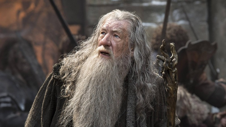 Gandalf is looking into the sky in Lord of the Rings.